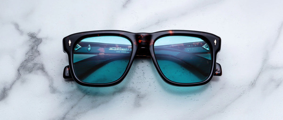 Jacques Marie Mage Yves square black sunglasses with blue lenses, front angle view, UV protection.