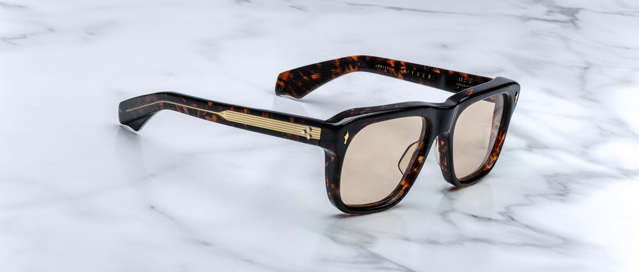 Jacques Marie Mage Yves square tortoiseshell sunglasses with gold-accented arms, shown from above.