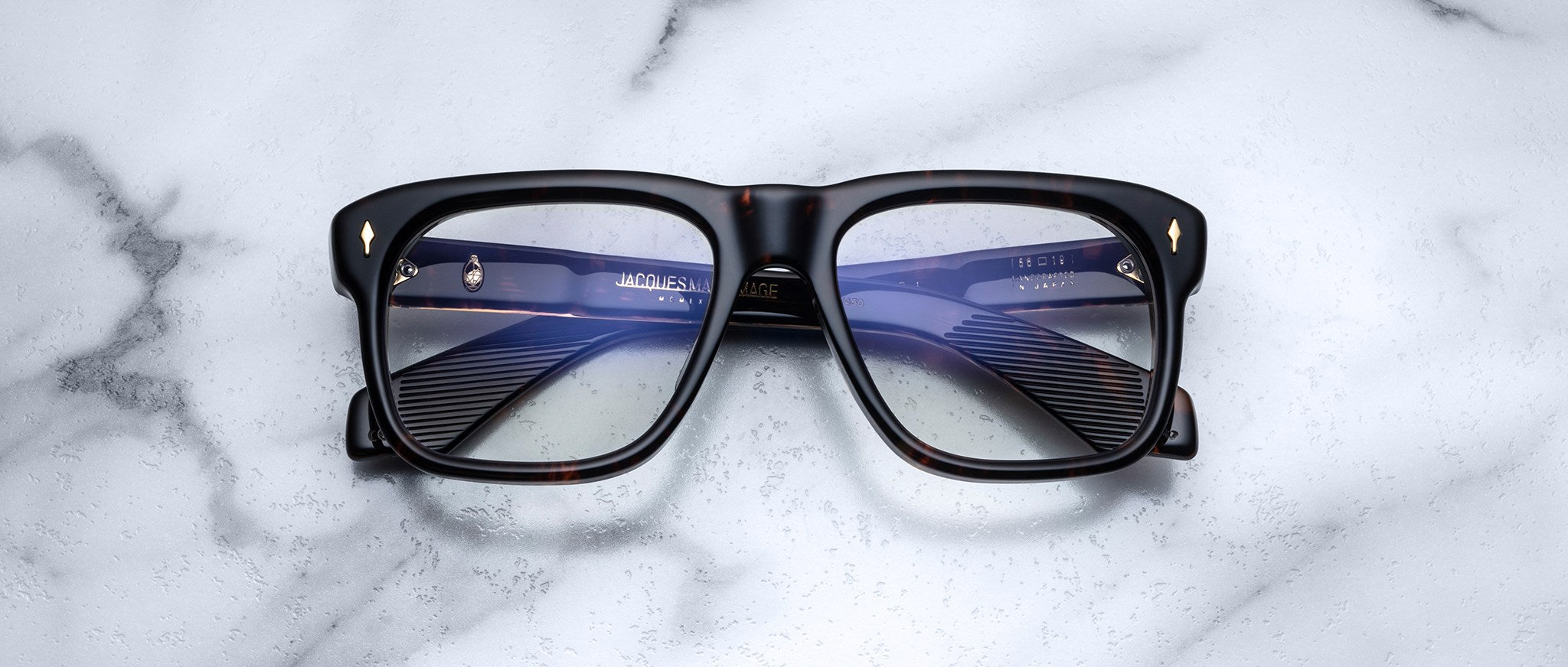 Jacques Marie Mage Yves black rectangular eyeglasses with clear lenses, front view.