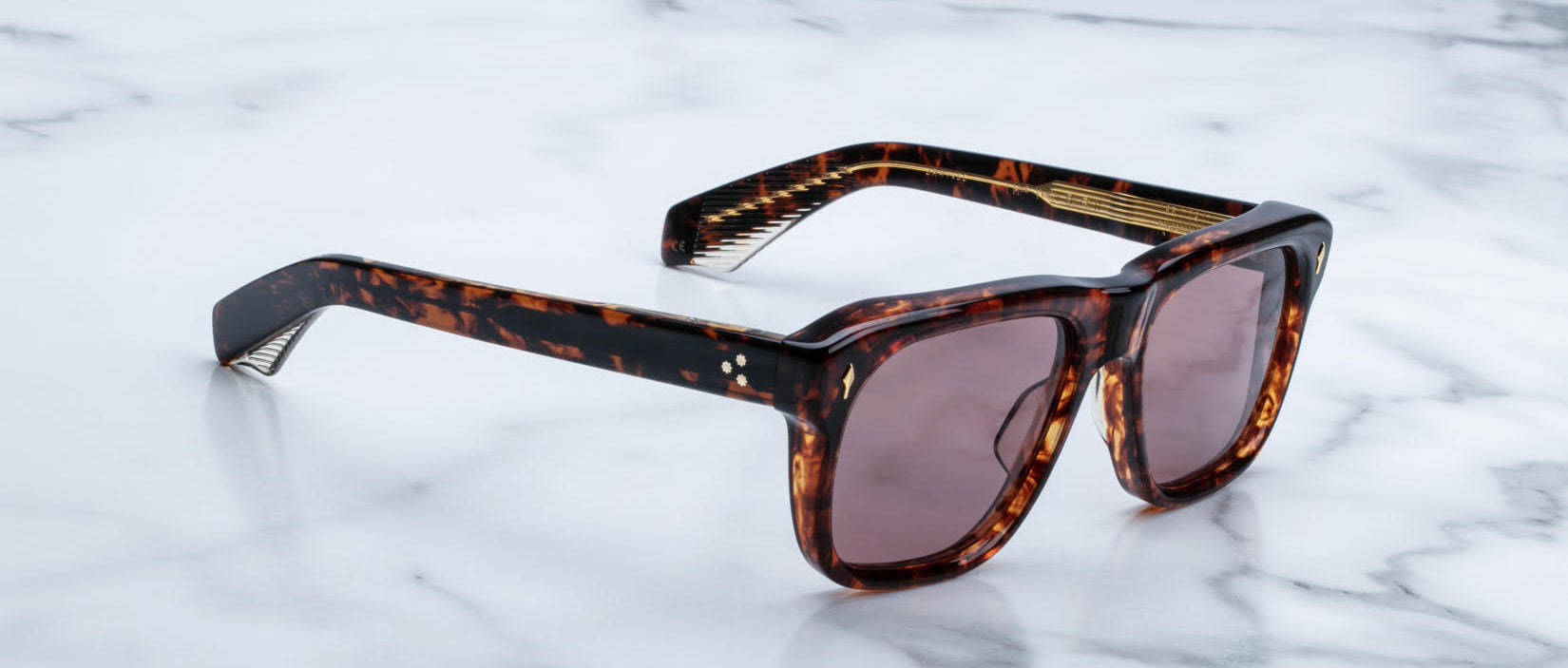 Jacques Marie Mage Yves tortoiseshell sunglasses with brown lenses and wide arms, shown from above.
