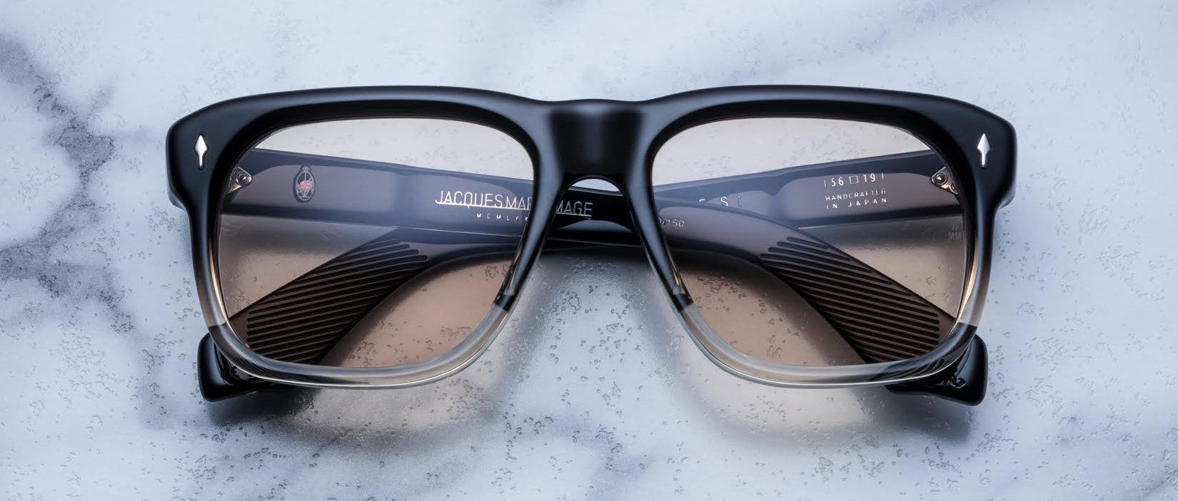 Jacques Marie Mage Yves rectangular black and clear eyeglasses with tinted lenses, front view.