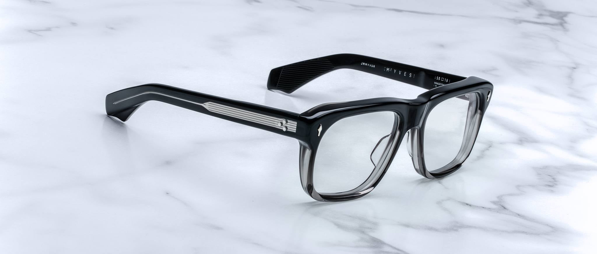 Jacques Marie Mage Yves black eyeglasses with clear lenses, classic design, shown from above.