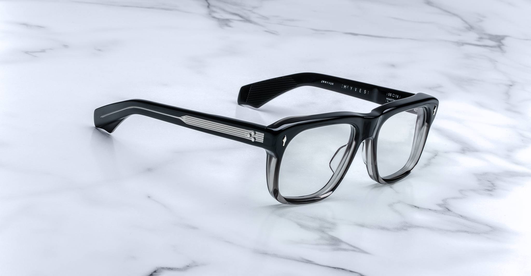 Jacques Marie Mage Yves black eyeglasses with clear lenses, classic design, shown from above.