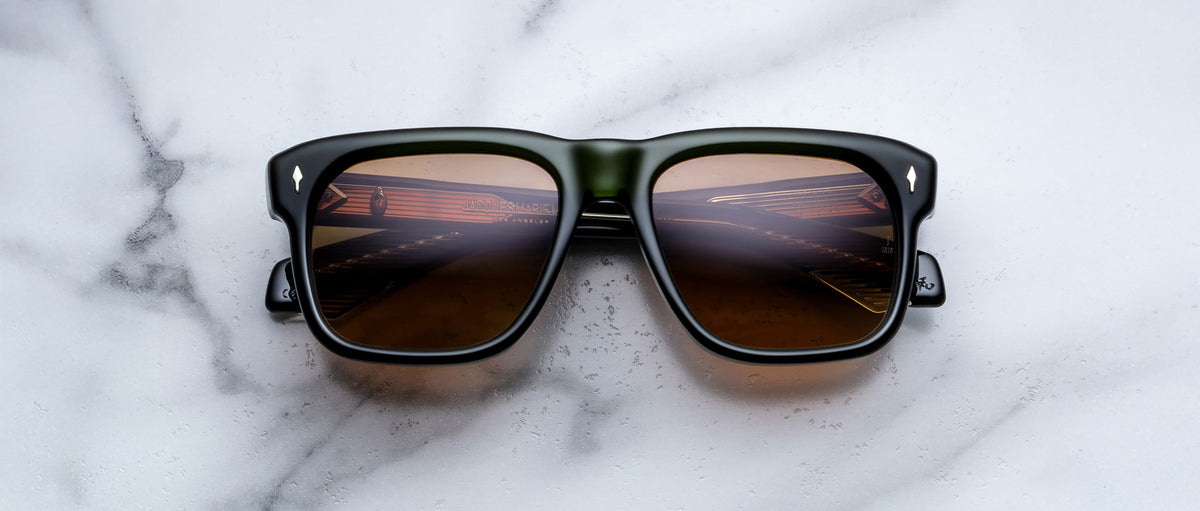 Jacques Marie Mage Yves black sunglasses with brown lenses, top view showing piano key reflections.