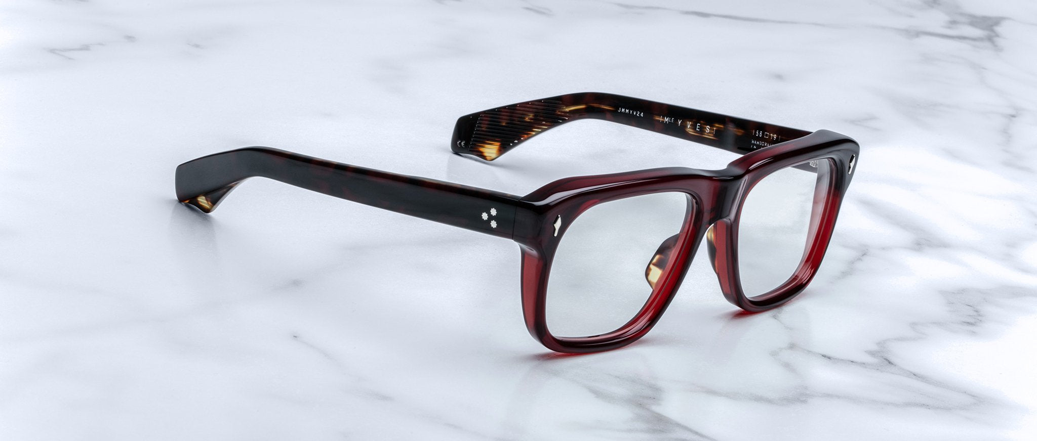 Jacques Marie Mage Yves rectangular dark red tortoiseshell eyeglasses with clear lenses, top view.