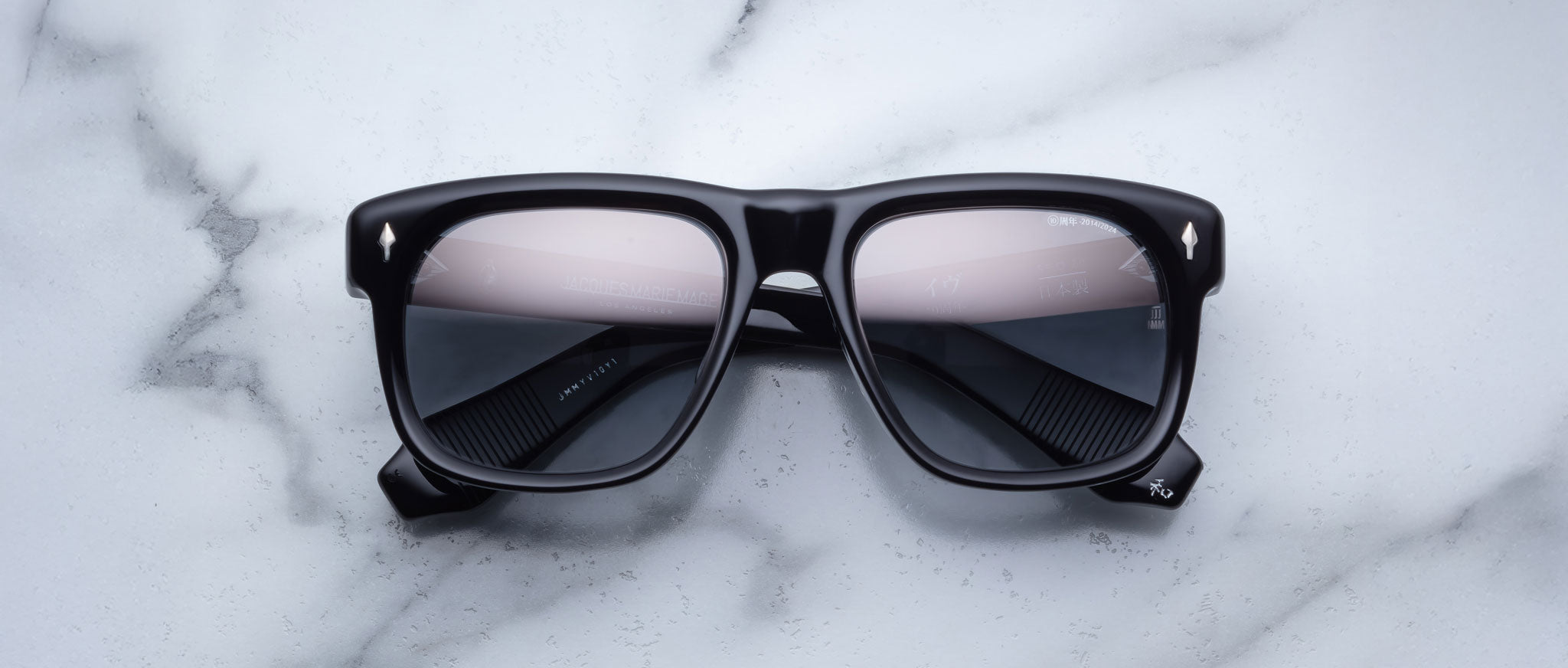Jacques Marie Mage Yves black rectangular sunglasses with tinted lenses, top view.