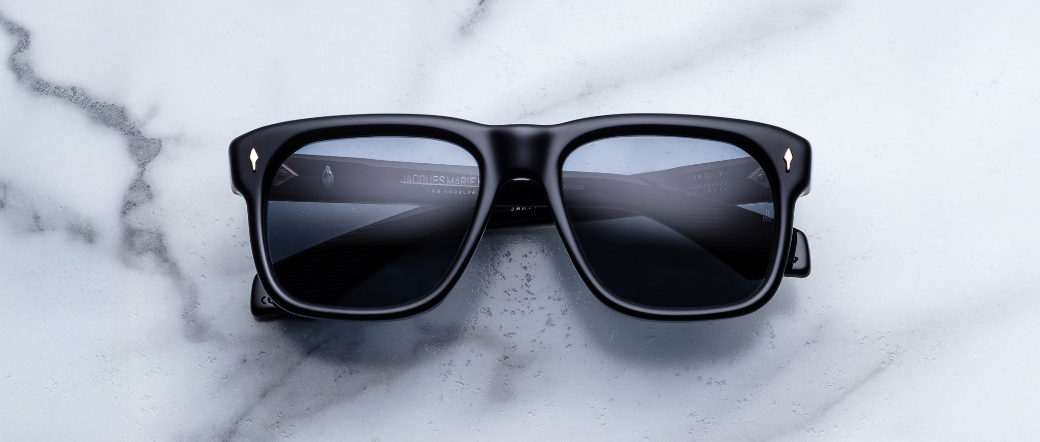 Jacques Marie Mage Yves in Lacquer Blue sunglasses, rectangular dark blue acetate frame with blue-tinted lenses and signature arrowhead rivets, front view
