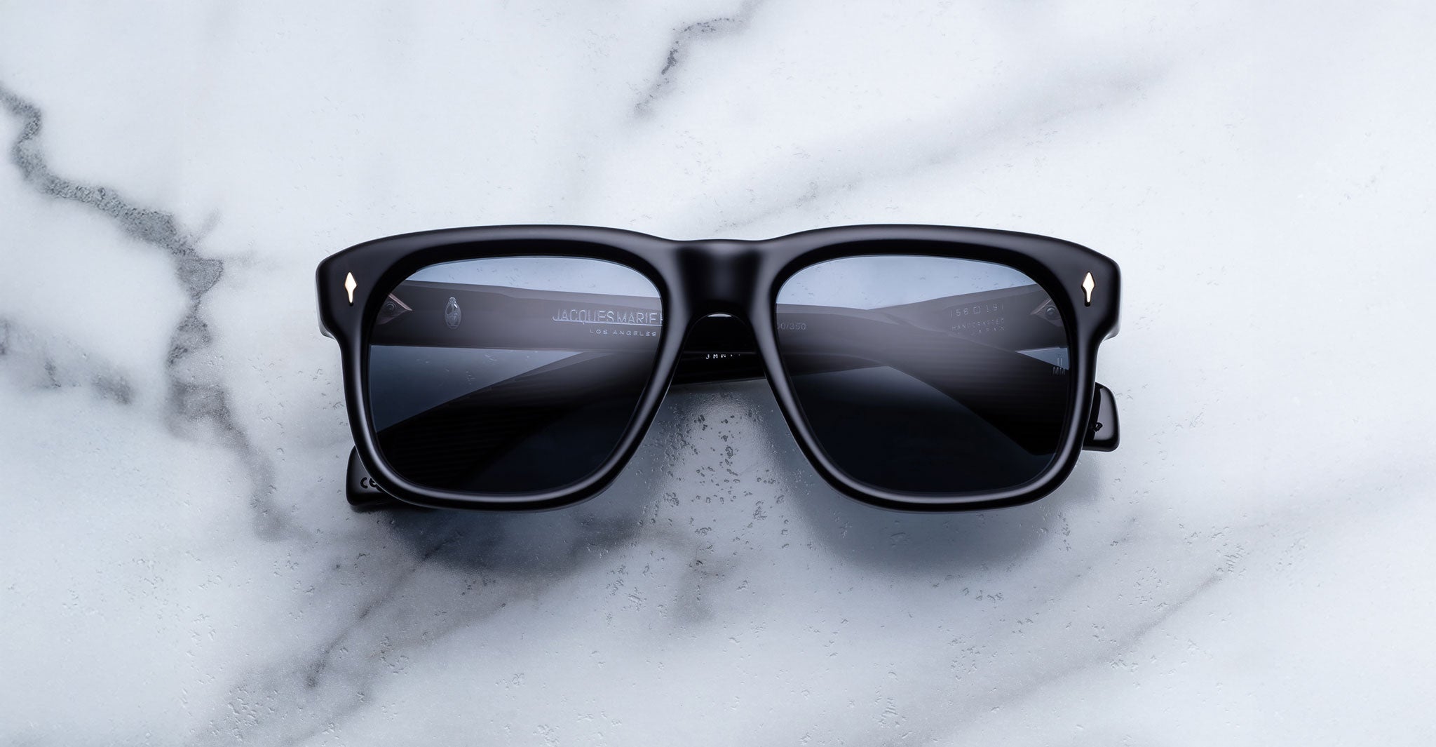 Jacques Marie Mage Yves in Lacquer Blue sunglasses, rectangular dark blue acetate frame with blue-tinted lenses and signature arrowhead rivets, front view
