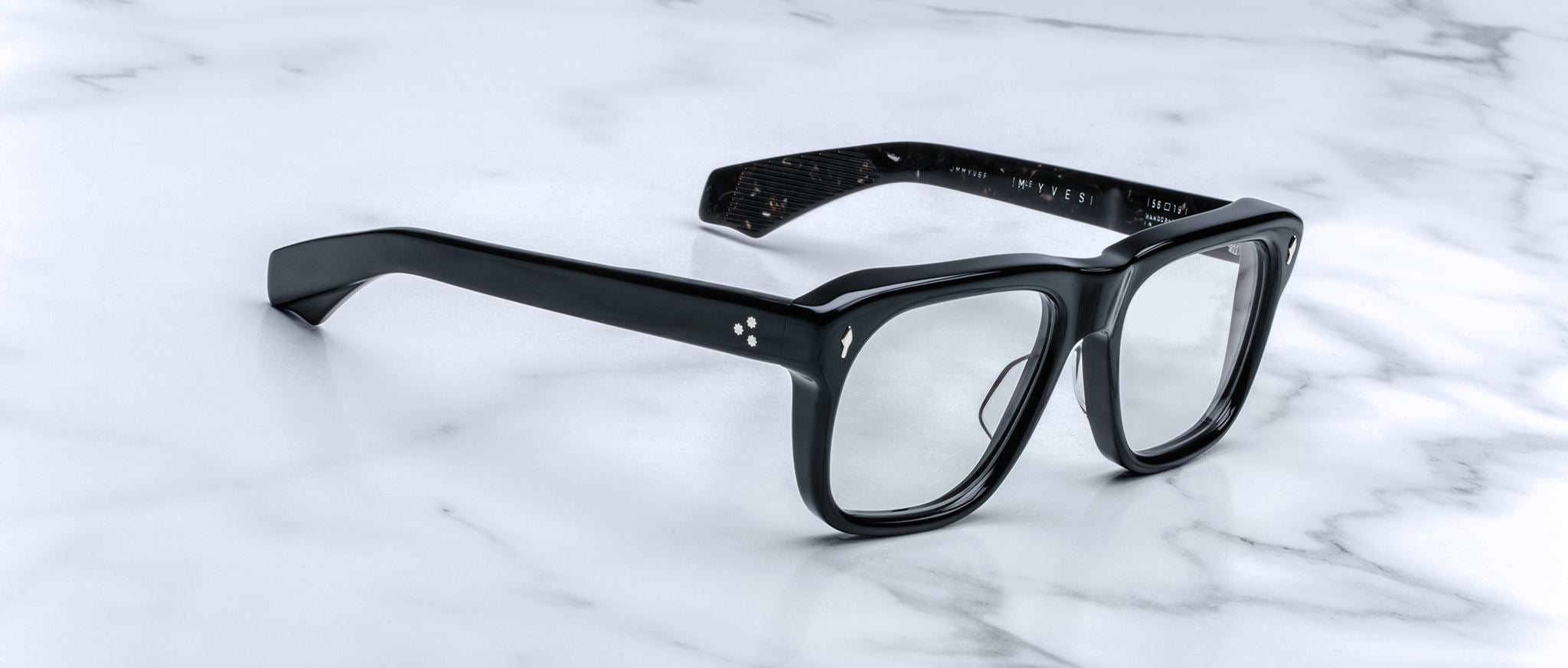 Jacques Marie Mage Yves black rectangular eyeglasses with clear lenses, product shown from above.