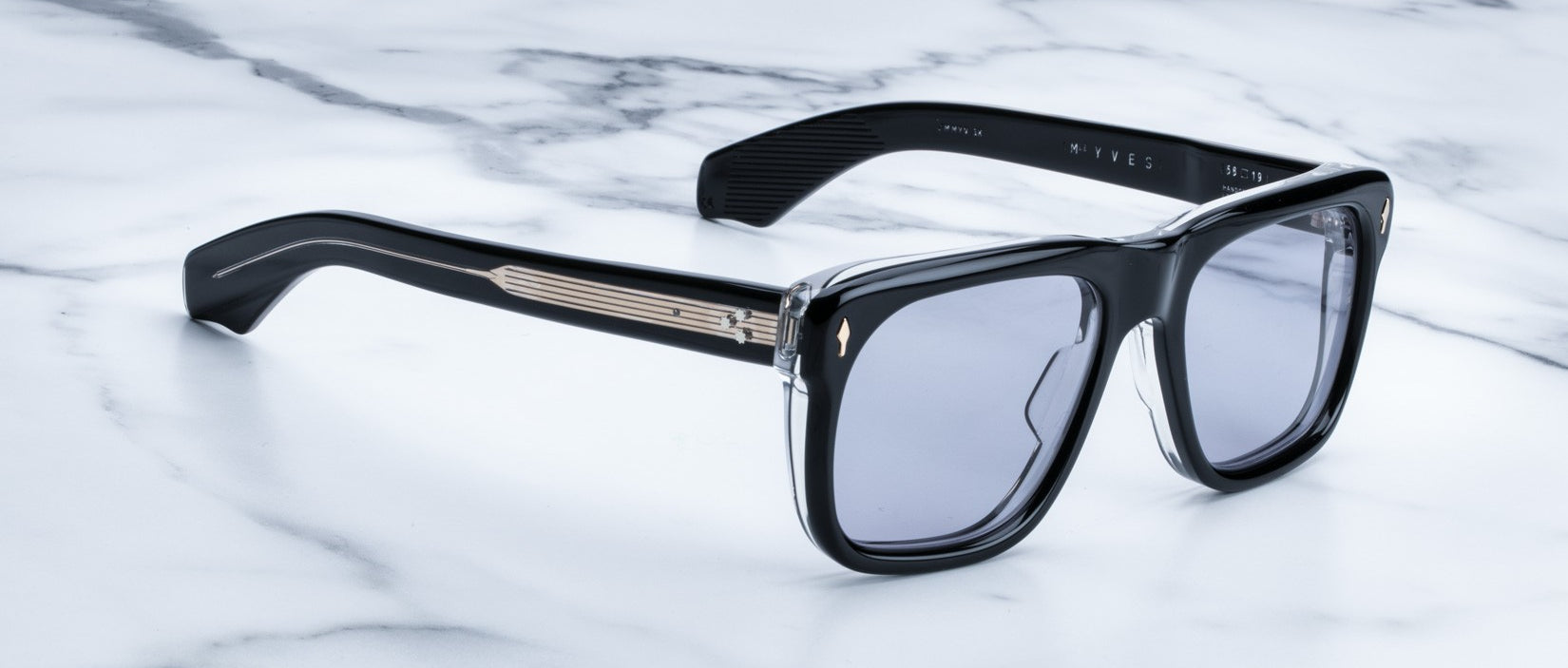 Jacques Marie Mage Yves black rectangular sunglasses with gold accents and dark lenses, profile view.