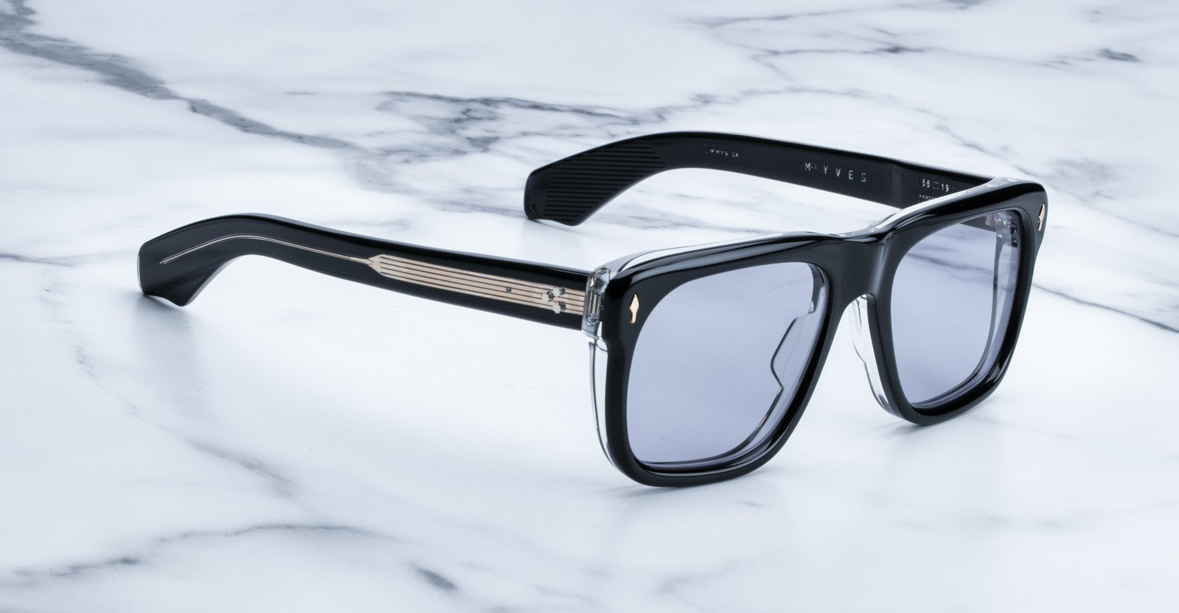 Jacques Marie Mage Yves black rectangular sunglasses with gold accents and dark lenses, profile view.