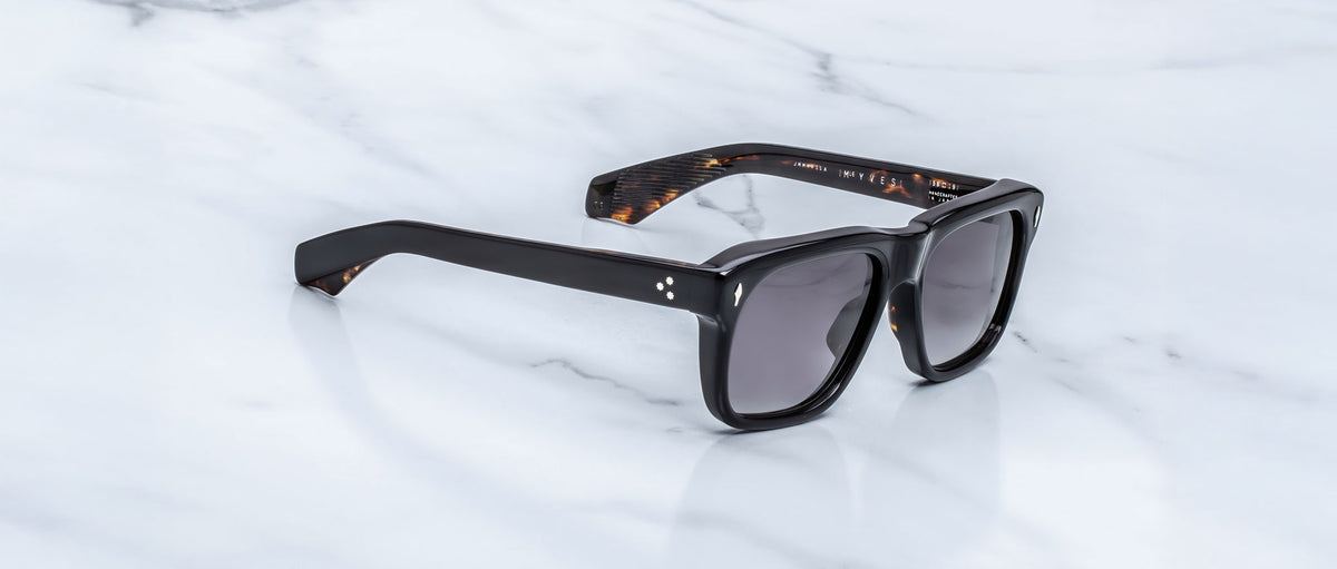 Jacques Marie Mage Yves black rectangular sunglasses with UV-protective lenses, top view.