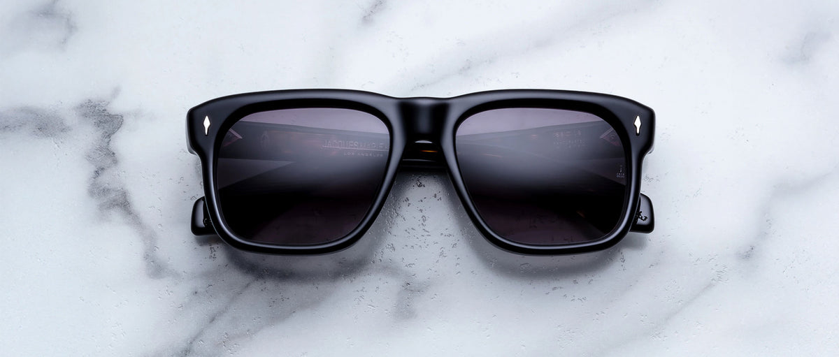 Jacques Marie Mage Yves sunglasses with dark lenses, top view, showing thick frames and branded design.