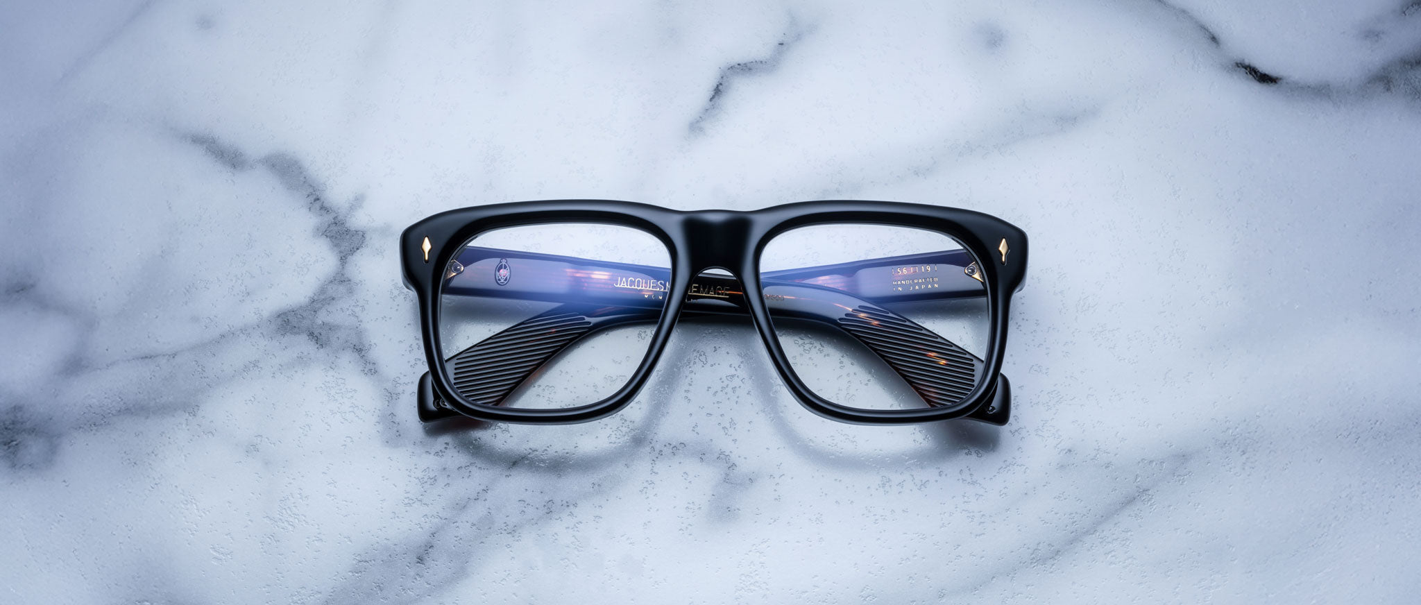 Jacques Marie Mage Yves black eyeglasses with clear lenses, front view. Eyeglass frame features rectangular shape.