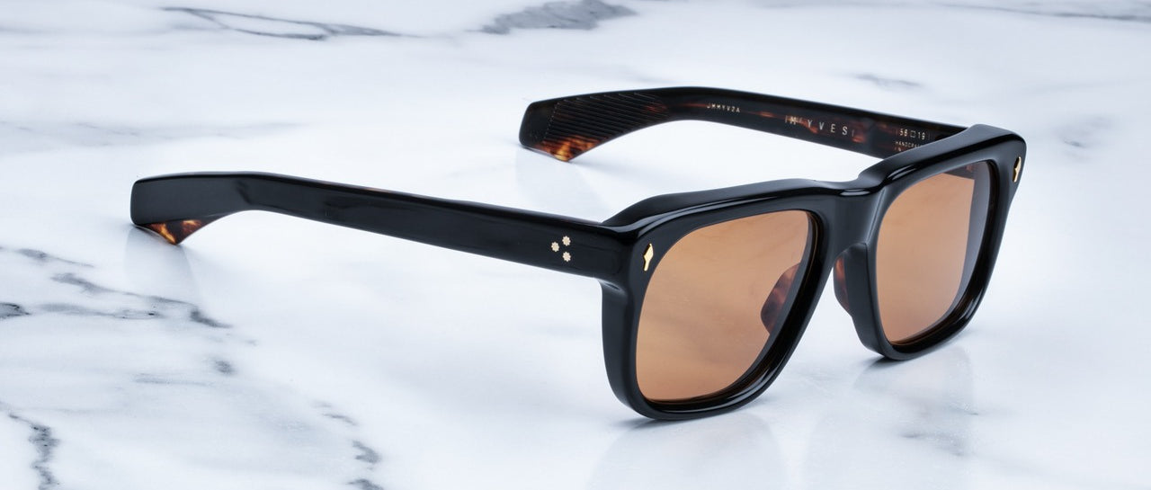 Jacques Marie Mage Yves black-framed sunglasses with brown lenses, shown from above.