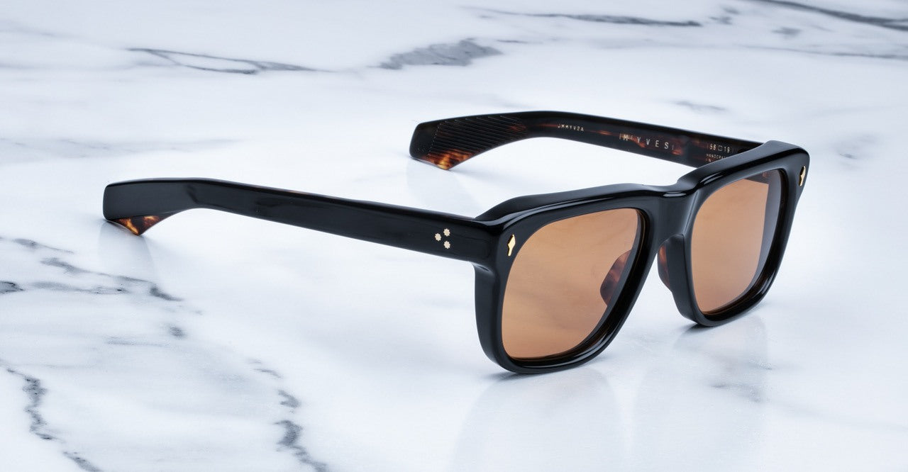 Jacques Marie Mage Yves black-framed sunglasses with brown lenses, shown from above.
