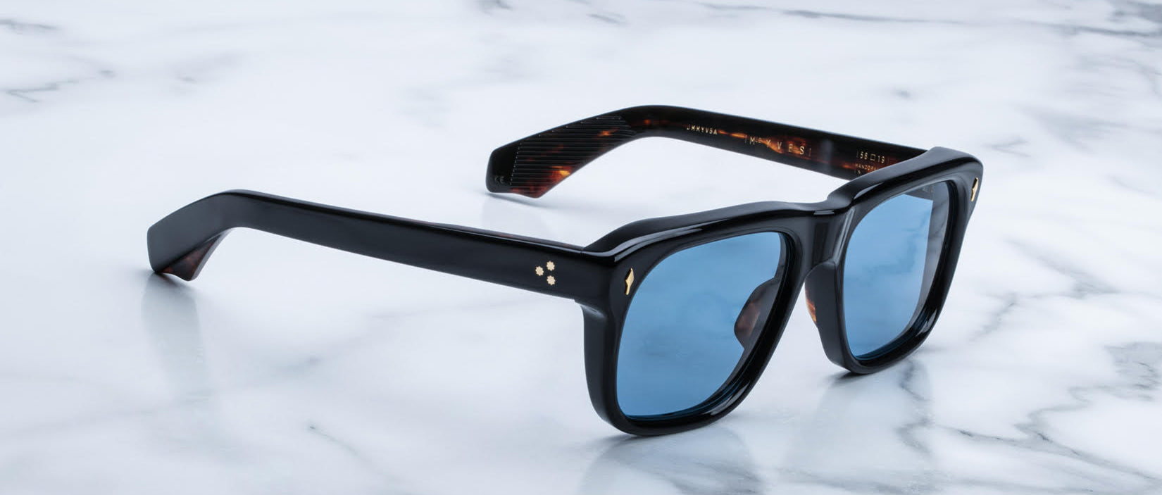 Jacques Marie Mage Yves black rectangular sunglasses with blue lenses, side view.