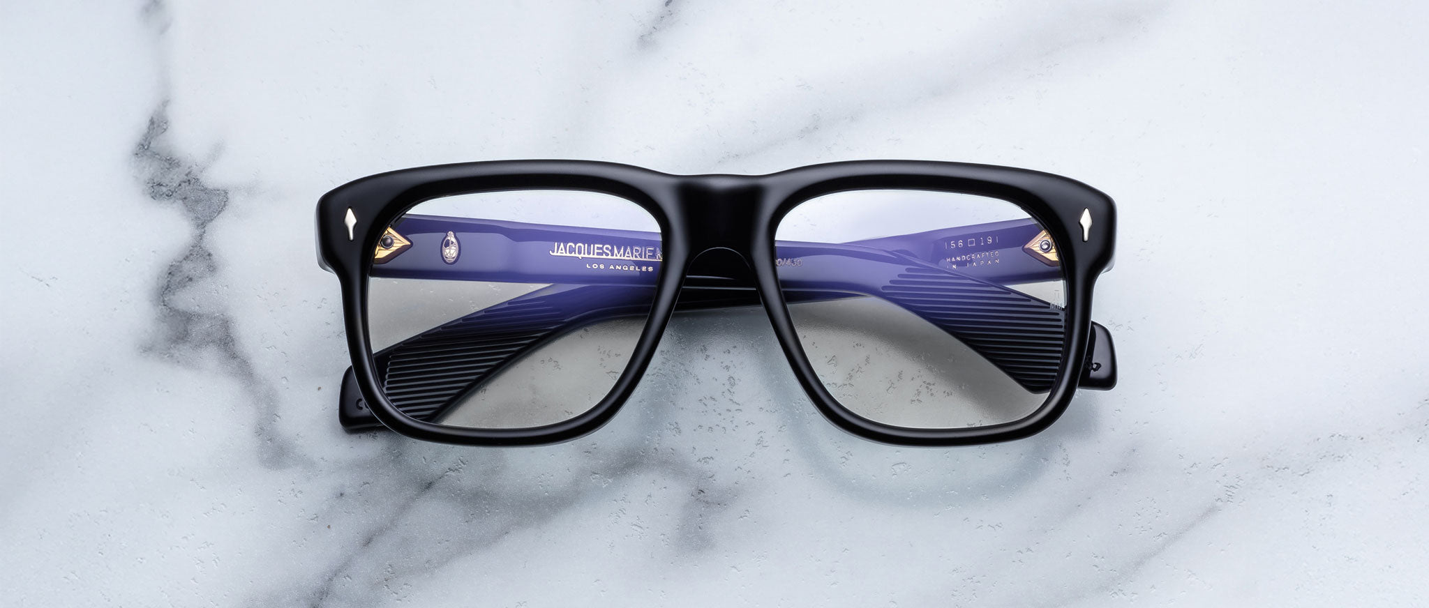 Jacques Marie Mage Yves in Obscure Black optical frame, rectangular matte black acetate frame with clear lenses and signature arrowhead rivets, front view