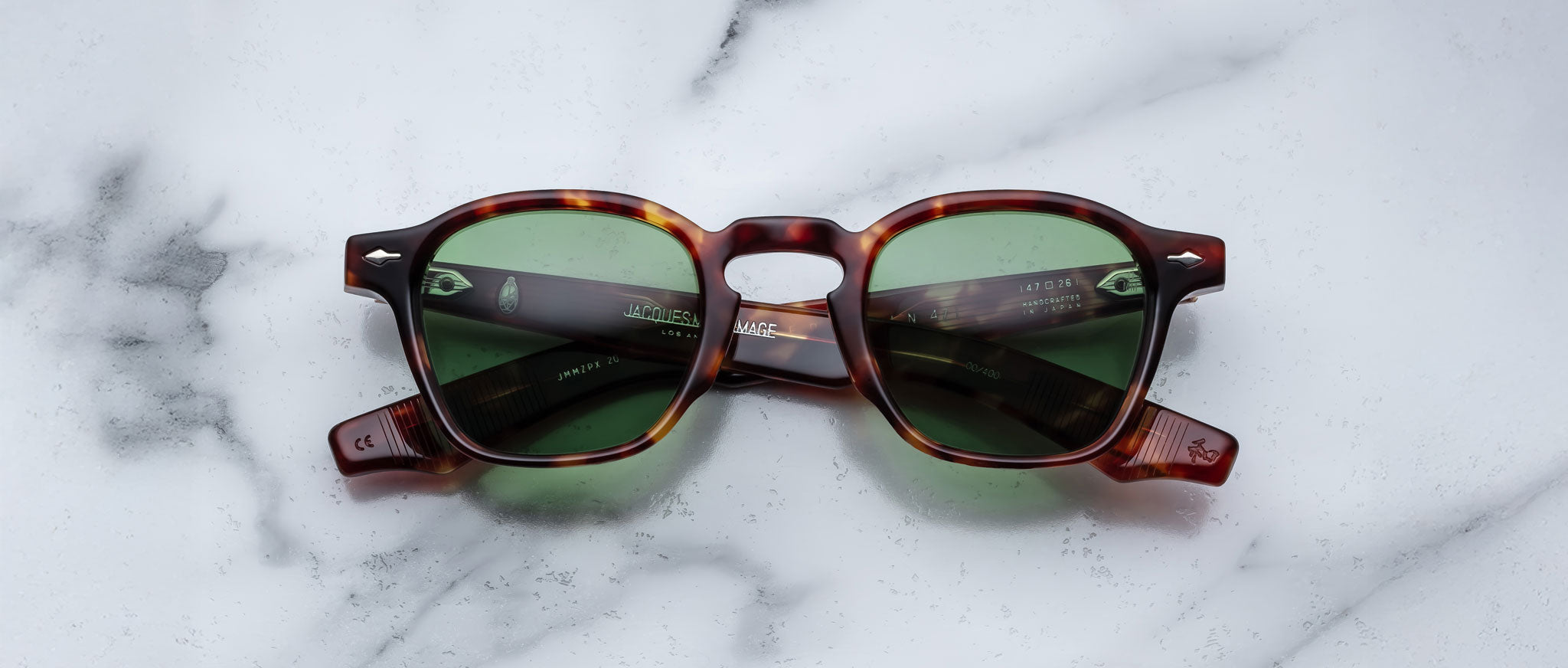Jacques Marie Mage Zephirin 47 sunglasses with green lenses, shown from above, display retro design and round frames.