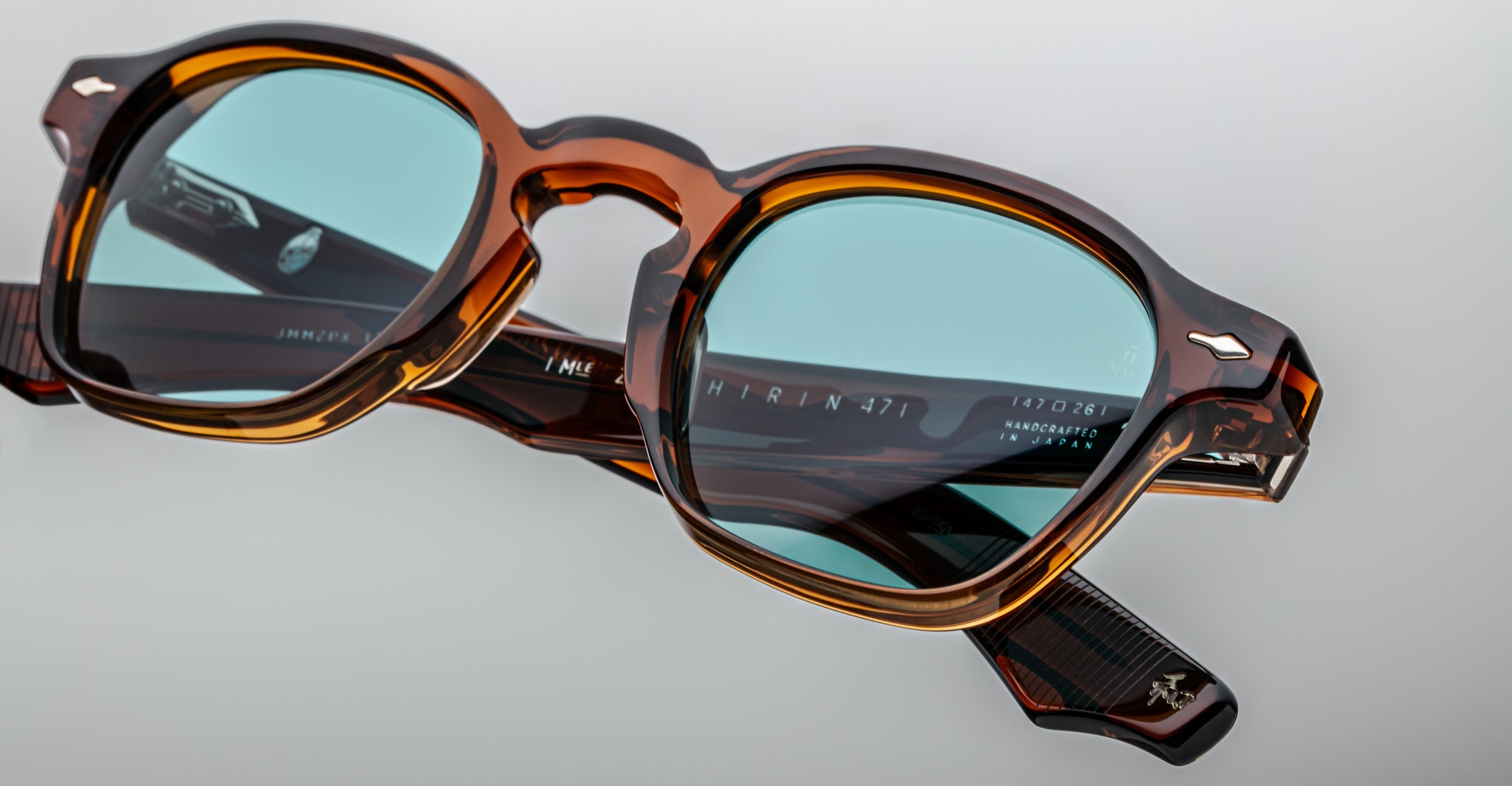 Close-up of Jacques Marie Mage Zephirin 47 eyeglasses in tortoiseshell with blue lenses, inner temple engraving visible.