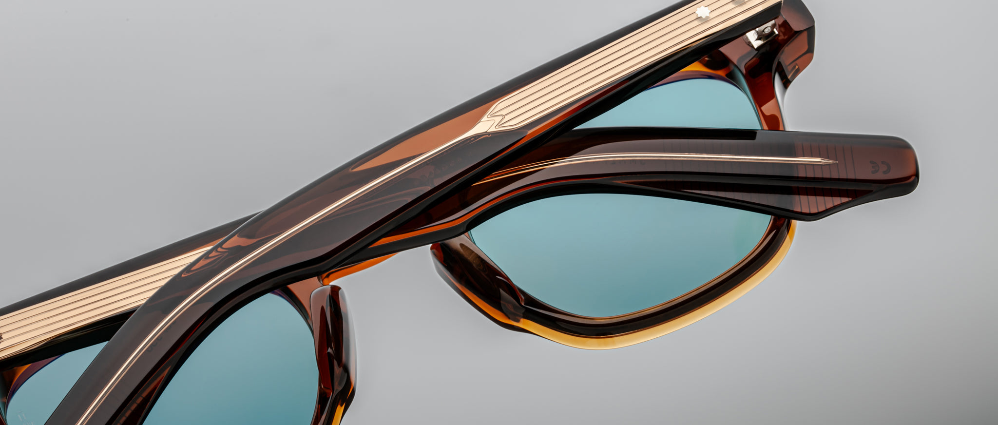 Jacques Marie Mage Zephirin 47 tortoiseshell sunglasses with blue lenses, shown in two stacked pairs, viewed from above.
