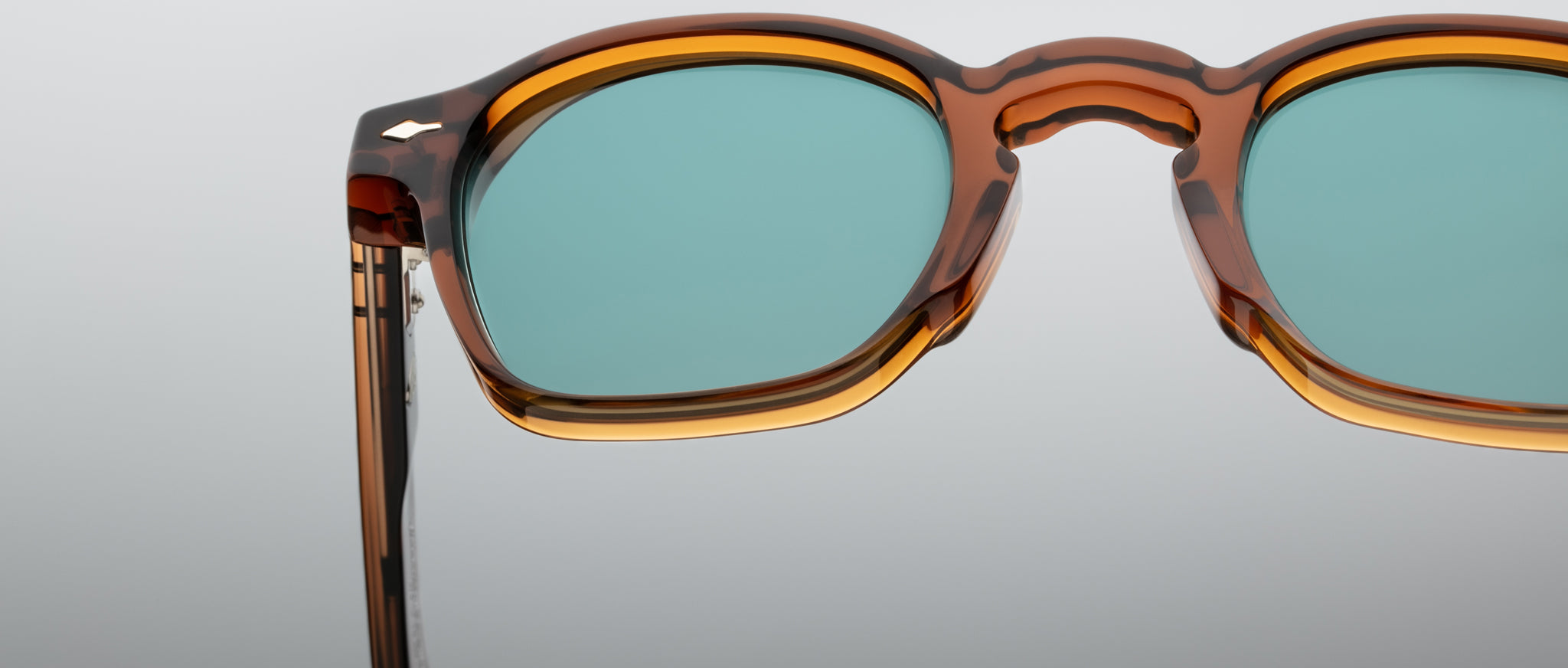 Close-up of Jacques Marie Mage Zephirin 47 sunglasses, tortoiseshell frame, blue-green lenses.