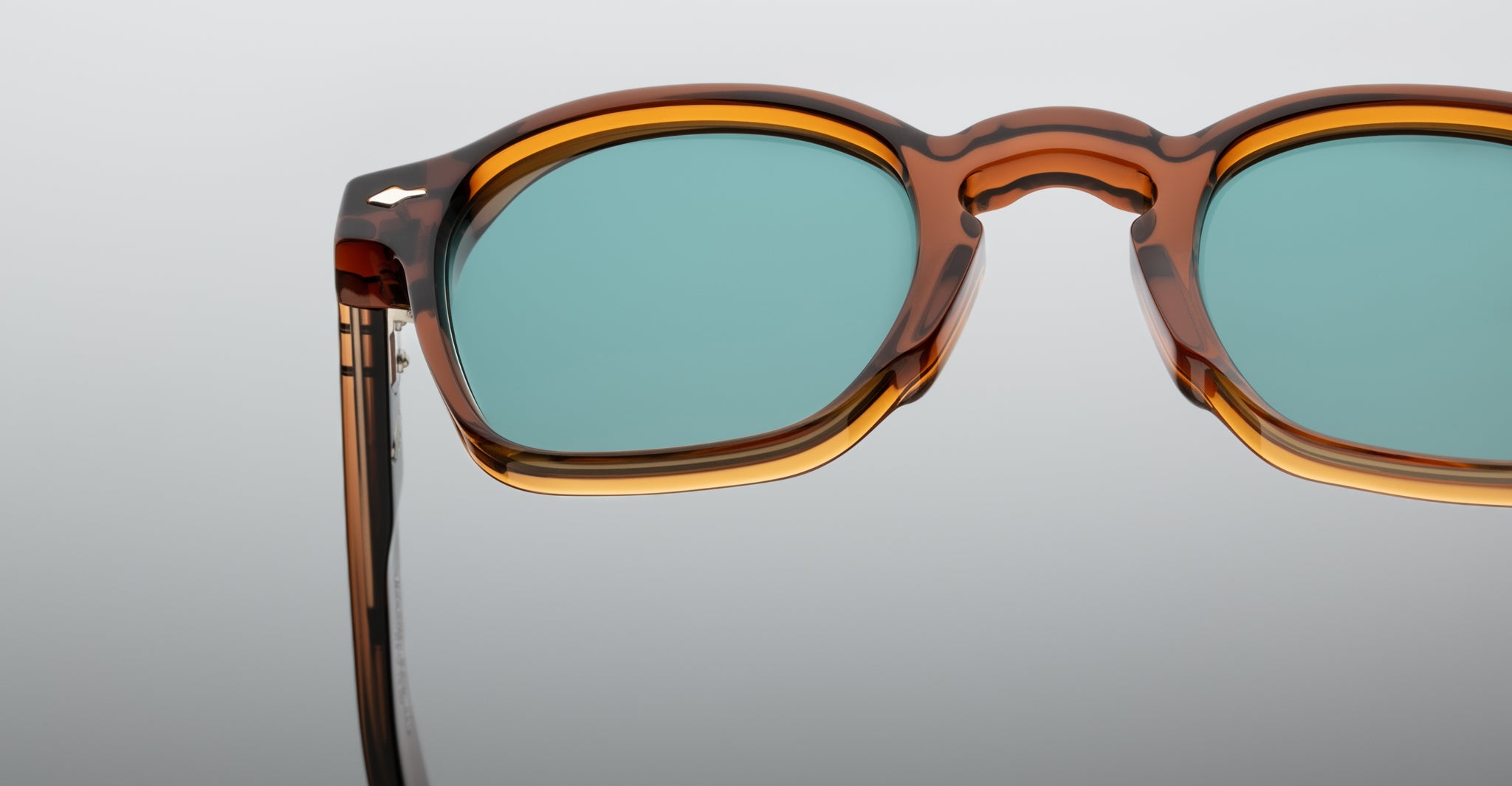 Close-up of Jacques Marie Mage Zephirin 47 sunglasses, tortoiseshell frame, blue-green lenses.