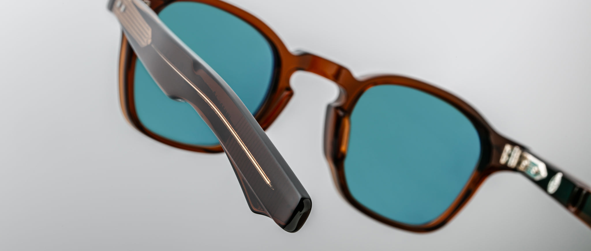 Close-up of Jacques Marie Mage Zephirin 47 sunglasses showing brown frames and blue lenses, viewed from the front.