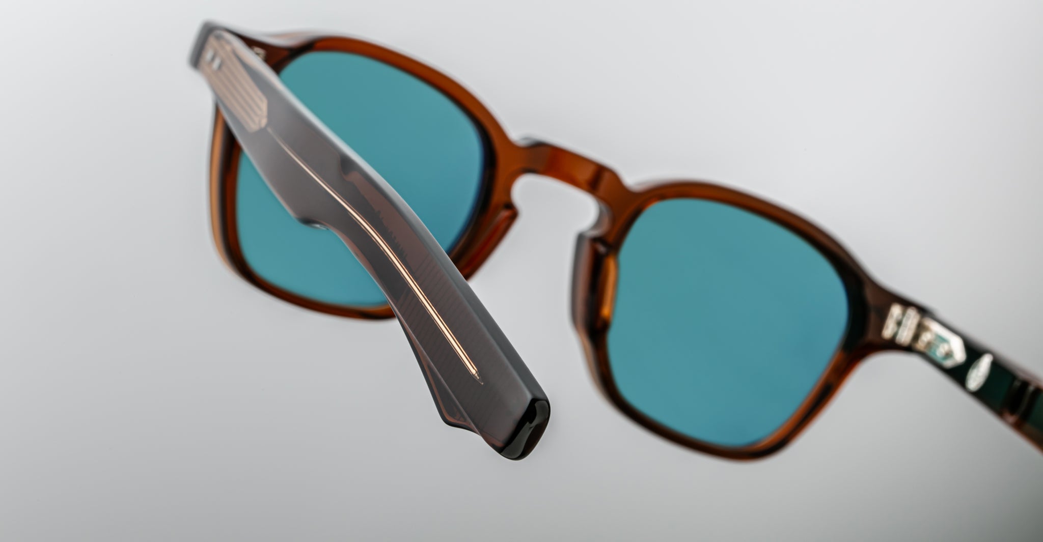 Close-up of Jacques Marie Mage Zephirin 47 sunglasses showing brown frames and blue lenses, viewed from the front.