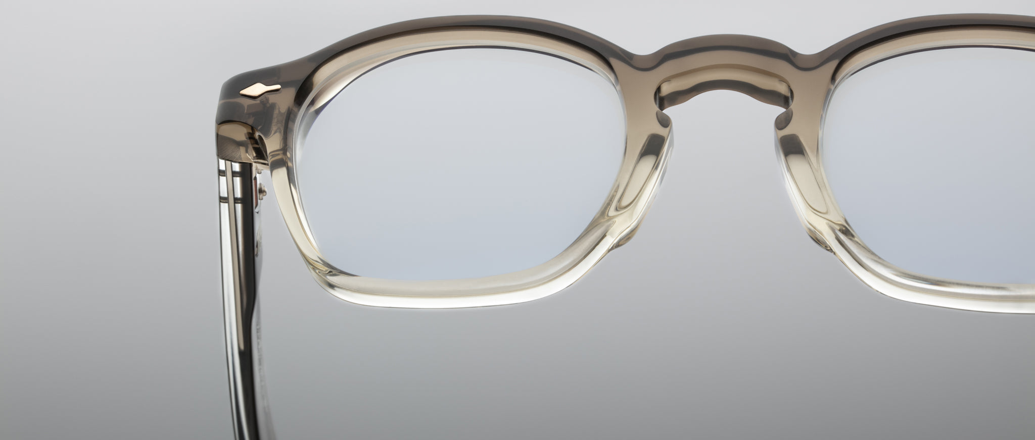 Close-up of Jacques Marie Mage Zephirin 47 light gray translucent eyeglasses with clear lenses, front view.