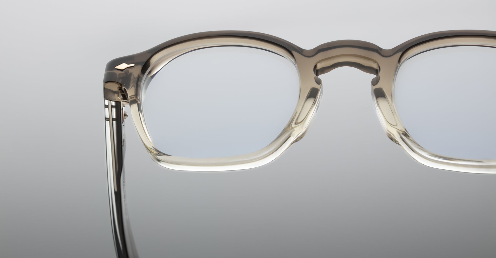 Close-up of Jacques Marie Mage Zephirin 47 light gray translucent eyeglasses with clear lenses, front view.