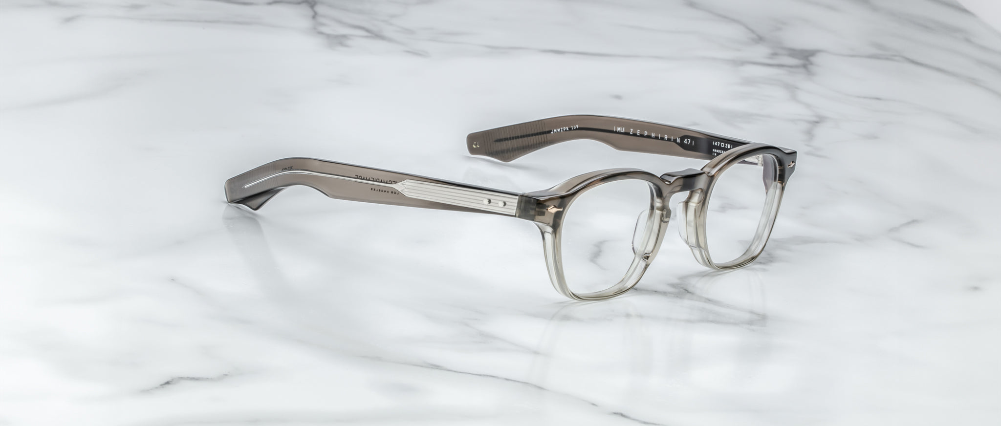 Jacques Marie Mage Zephirin 47 round gray transparent eyeglasses, top view, displayed on a flat surface.