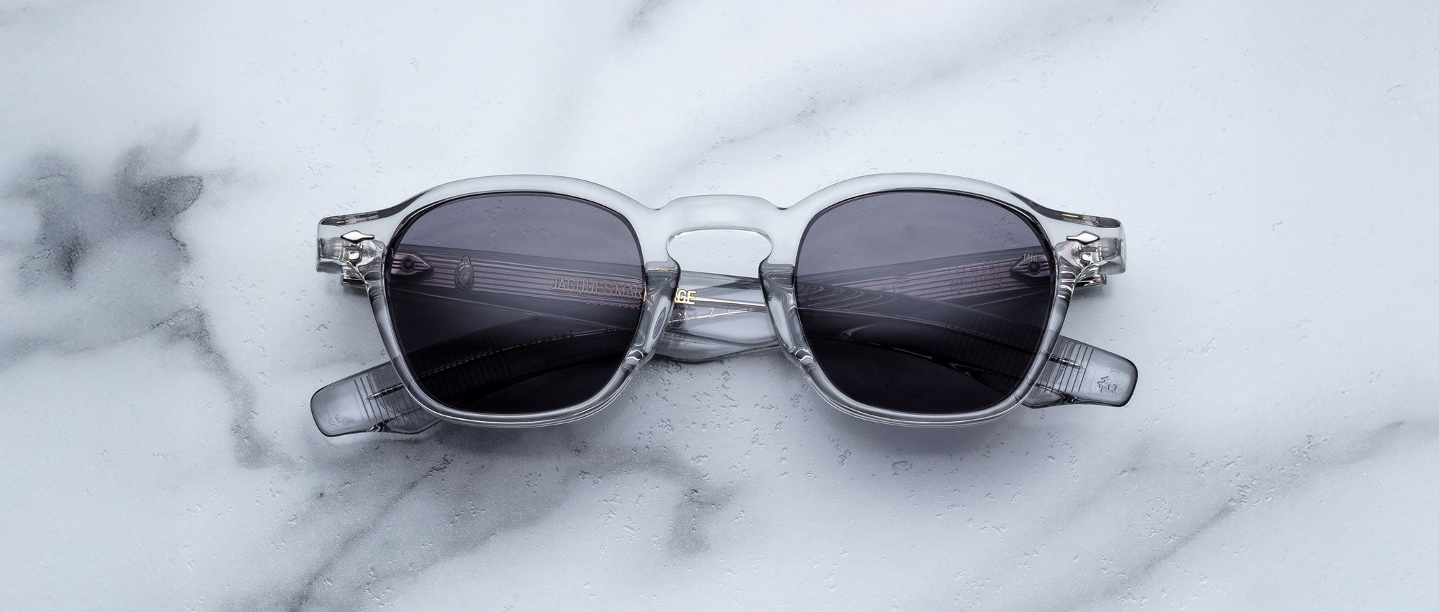 Jacques Marie Mage Zephirin 47 sunglasses with gray frames and dark lenses, top view.