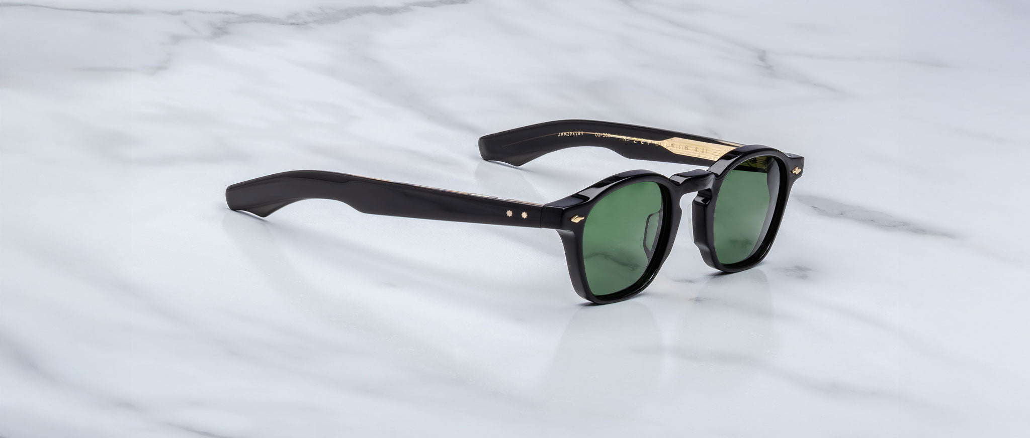 Jacques Marie Mage Zephirin 47 sunglasses, black frames, green lenses, gold accents, front angle view.