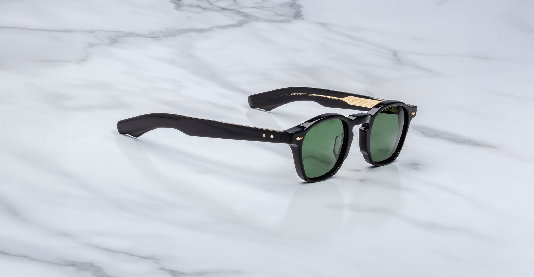Jacques Marie Mage Zephirin 47 sunglasses, black frames, green lenses, gold accents, front angle view.