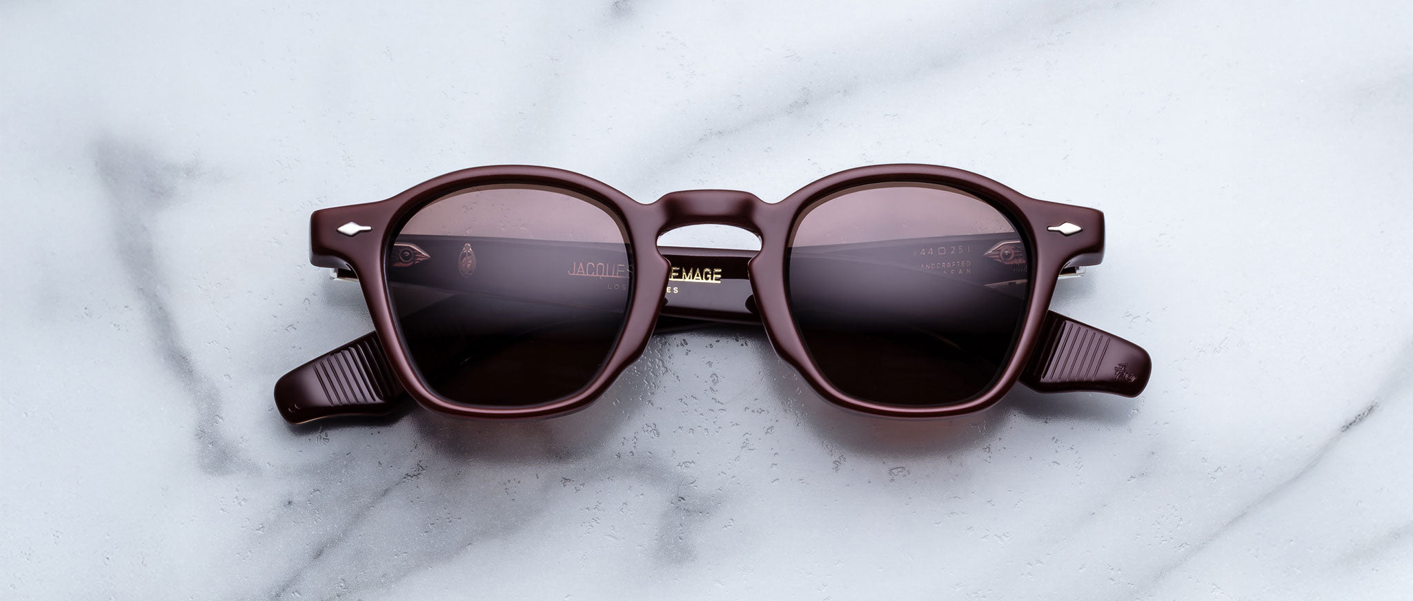 Jacques Marie Mage Zephirin Bordeaux Empire round sunglasses, burgundy frame and lenses, top-down view.
