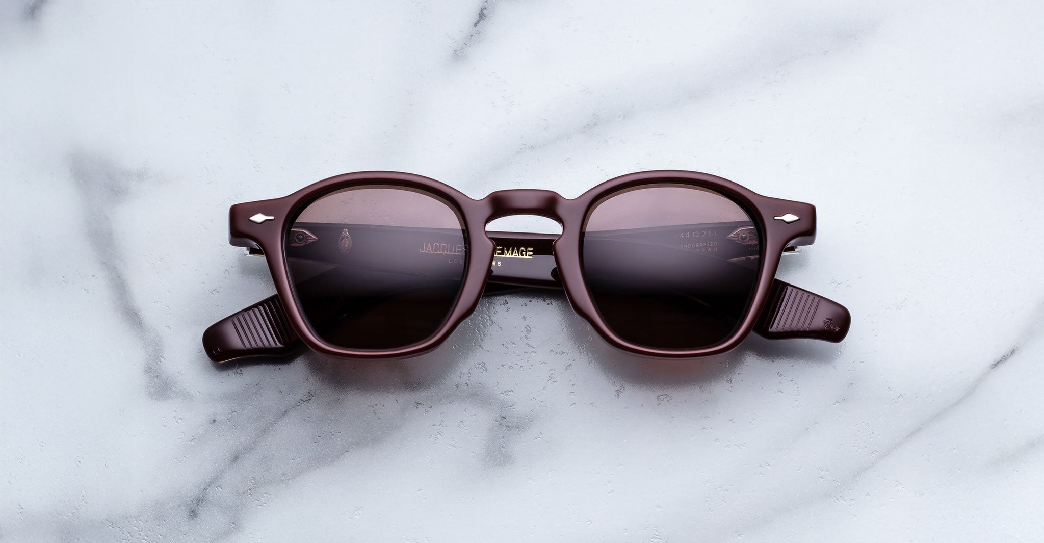 Jacques Marie Mage Zephirin Bordeaux Empire round sunglasses, burgundy frame and lenses, top-down view.