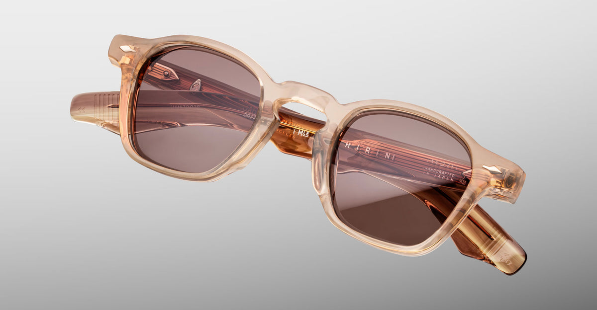 Jacques Marie Mage Zephirin sunglasses in Casliza, angled front detail with translucent amber acetate and rose-tinted lenses.