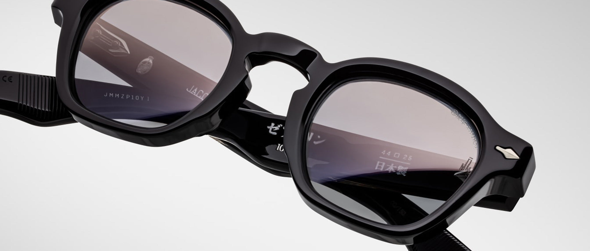 Close-up of Jacques Marie Mage Zephirin spectacles by Jacques Marie Mage—handcrafted acetate frames with lightly tinted lenses and white details on the inner temples; a true limited edition eyewear piece.