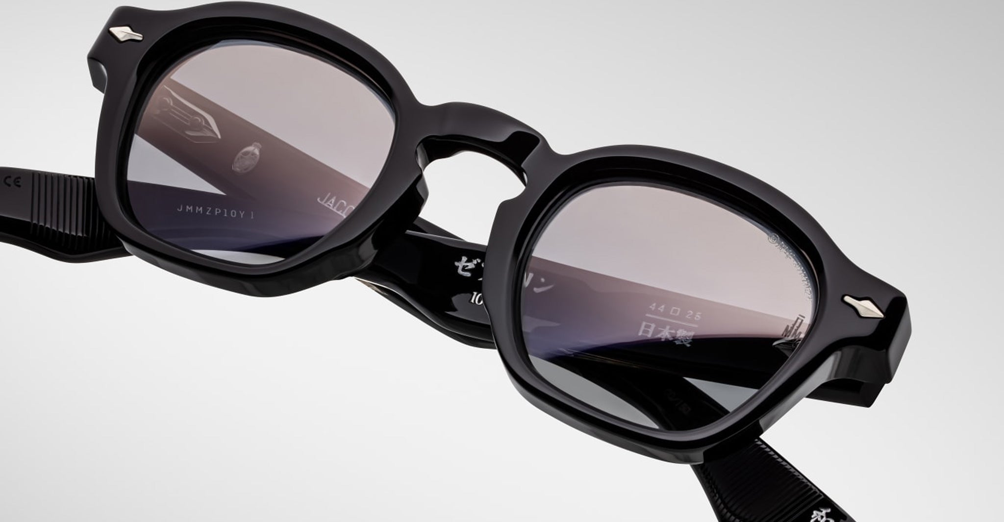 Close-up of Jacques Marie Mage Zephirin spectacles by Jacques Marie Mage—handcrafted acetate frames with lightly tinted lenses and white details on the inner temples; a true limited edition eyewear piece.