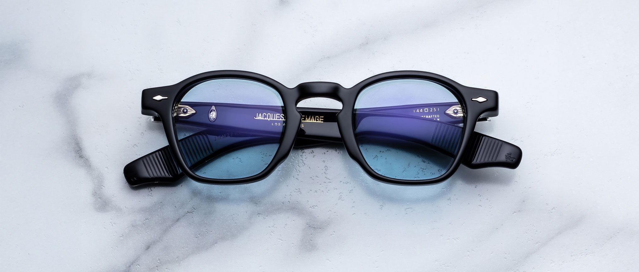 Jacques Marie Mage Zephirin in Obscure black round eyeglasses with blue-tinted lenses, front view.