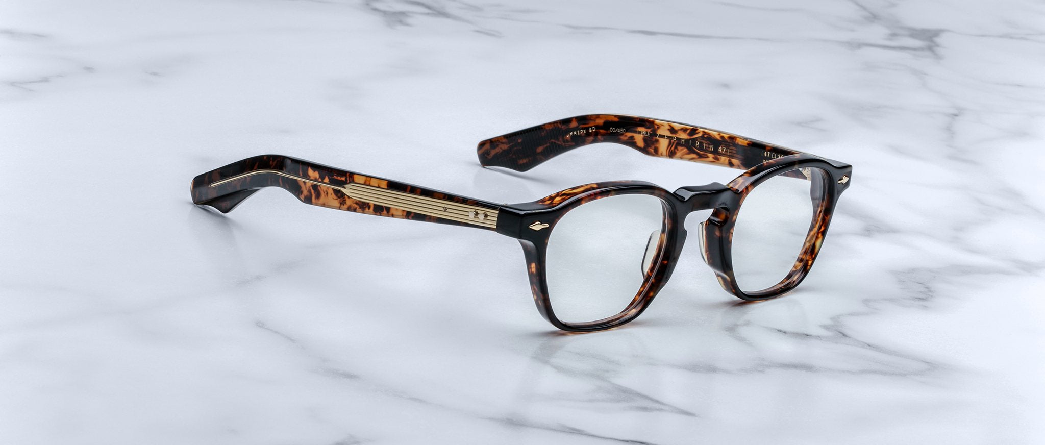 Jacques Marie Mage Zephirin 47 round tortoiseshell eyeglasses with gold accents, viewed from above.