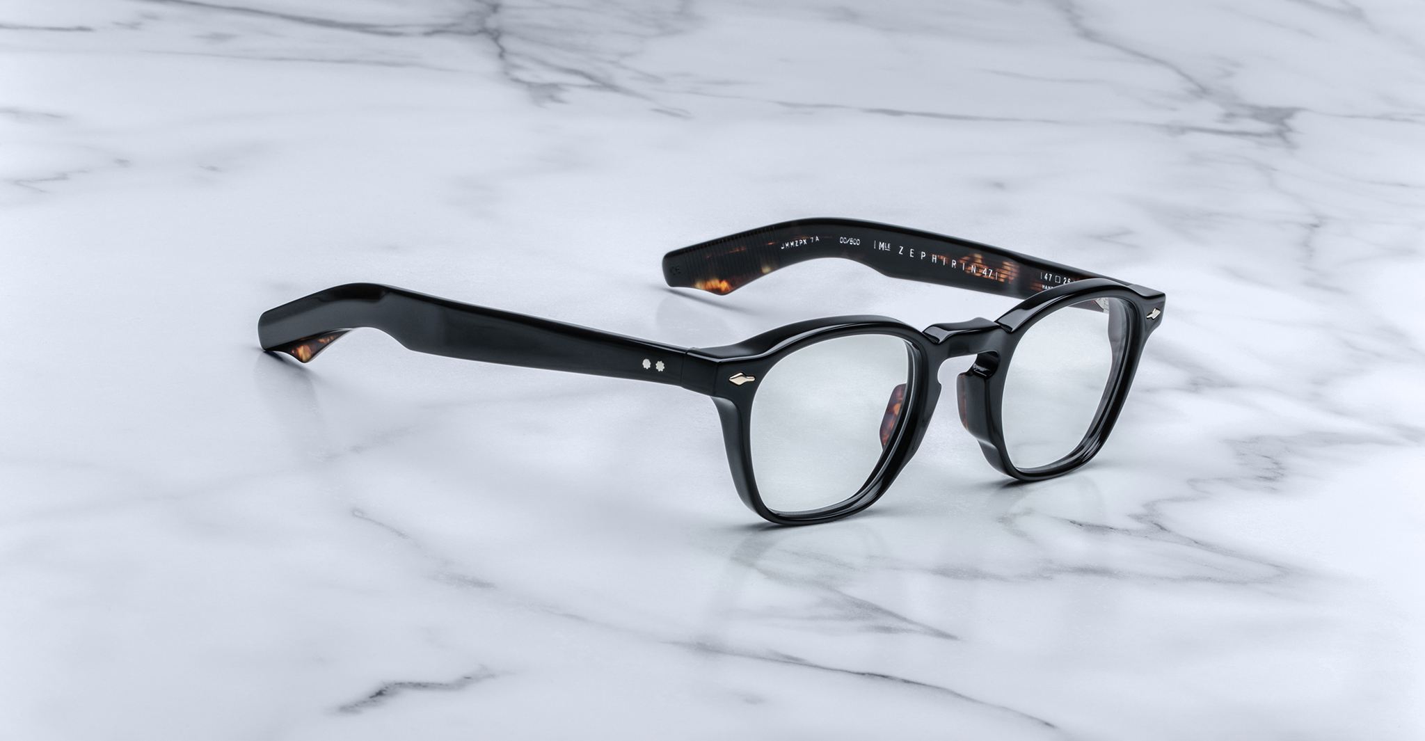 Jacques Marie Mage Zephirin 47 black eyeglasses with clear lenses, lightweight arms partially open, viewed from above.