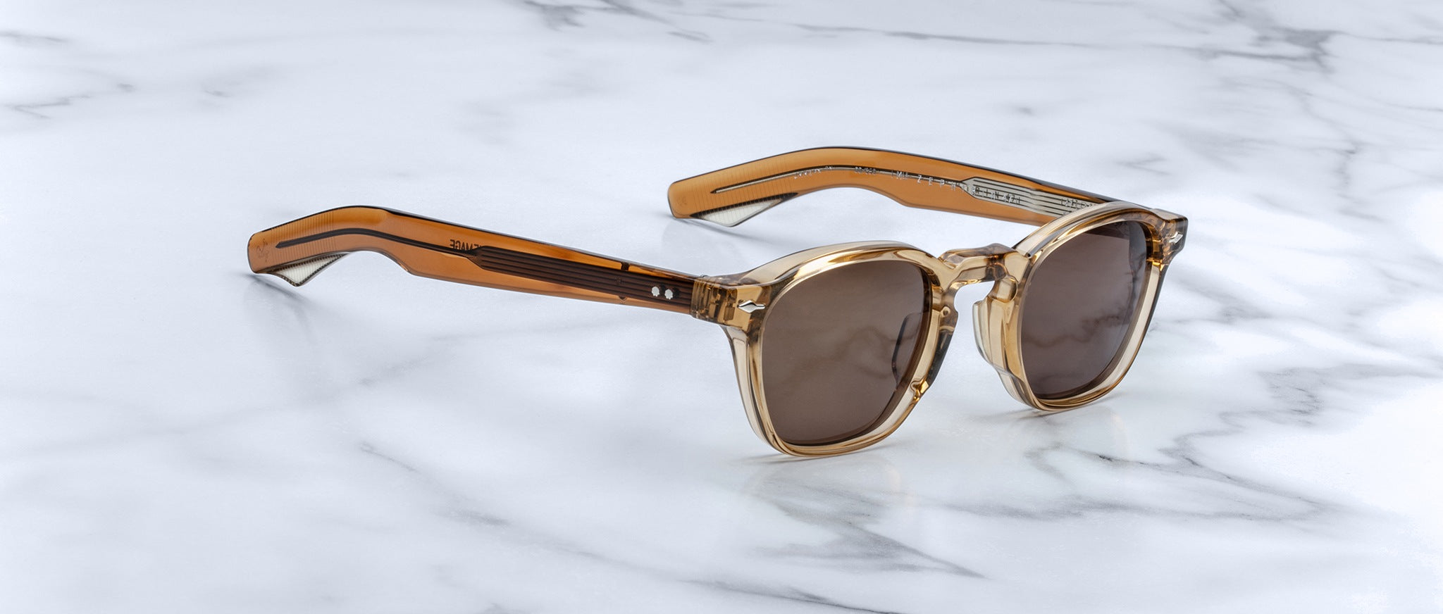 Jacques Marie Mage Zephirin 47 sunglasses with transparent brown frames, profile view.