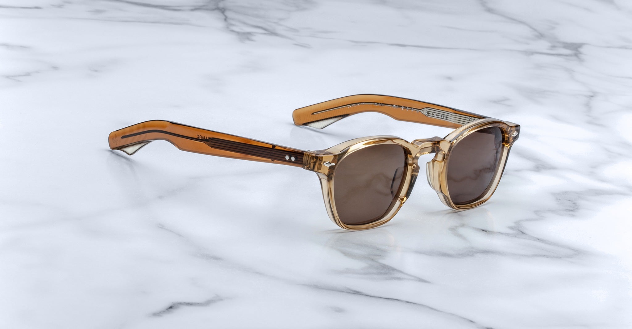 Jacques Marie Mage Zephirin 47 sunglasses with transparent brown frames, profile view.