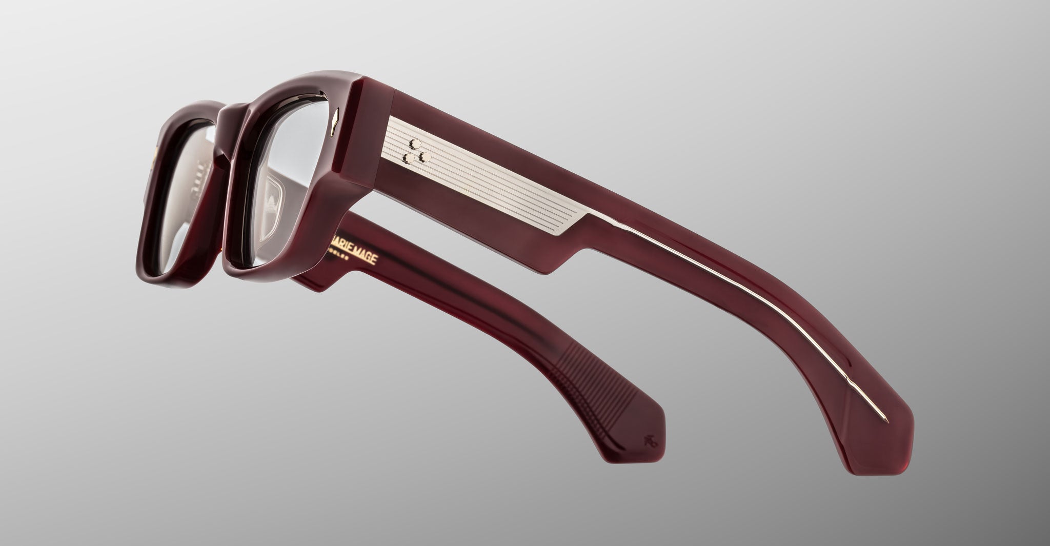 Jacques Marie Mage Zimmerman optical glasses in Bordeaux Empire red acetate with bold rectangular frame, clear lenses, and wide temples with signature metal core detail, side view