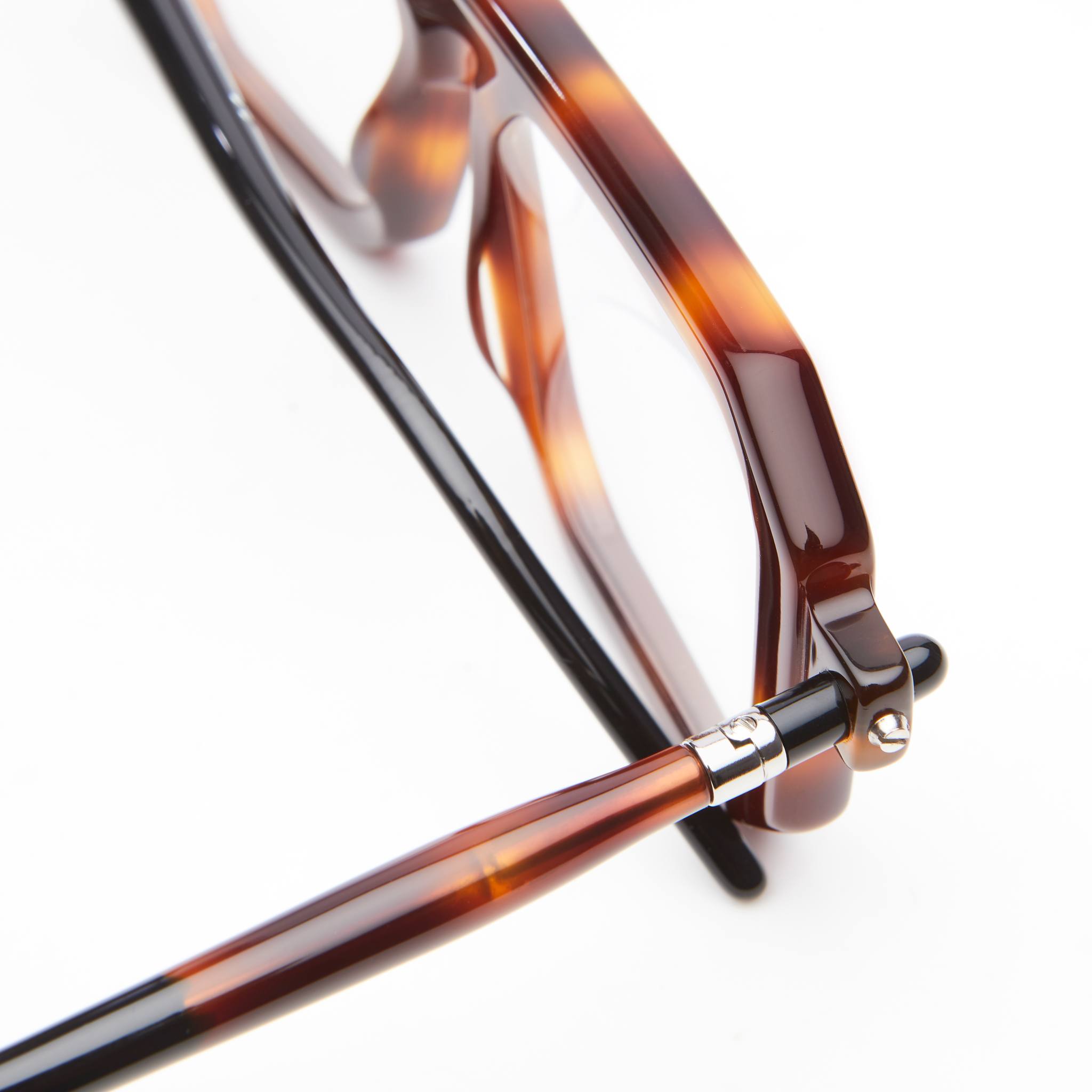 Close-up of KUBORAUM P8 tortoiseshell eyeglasses frame, showing metal hinge and acetate detail from a side angle.