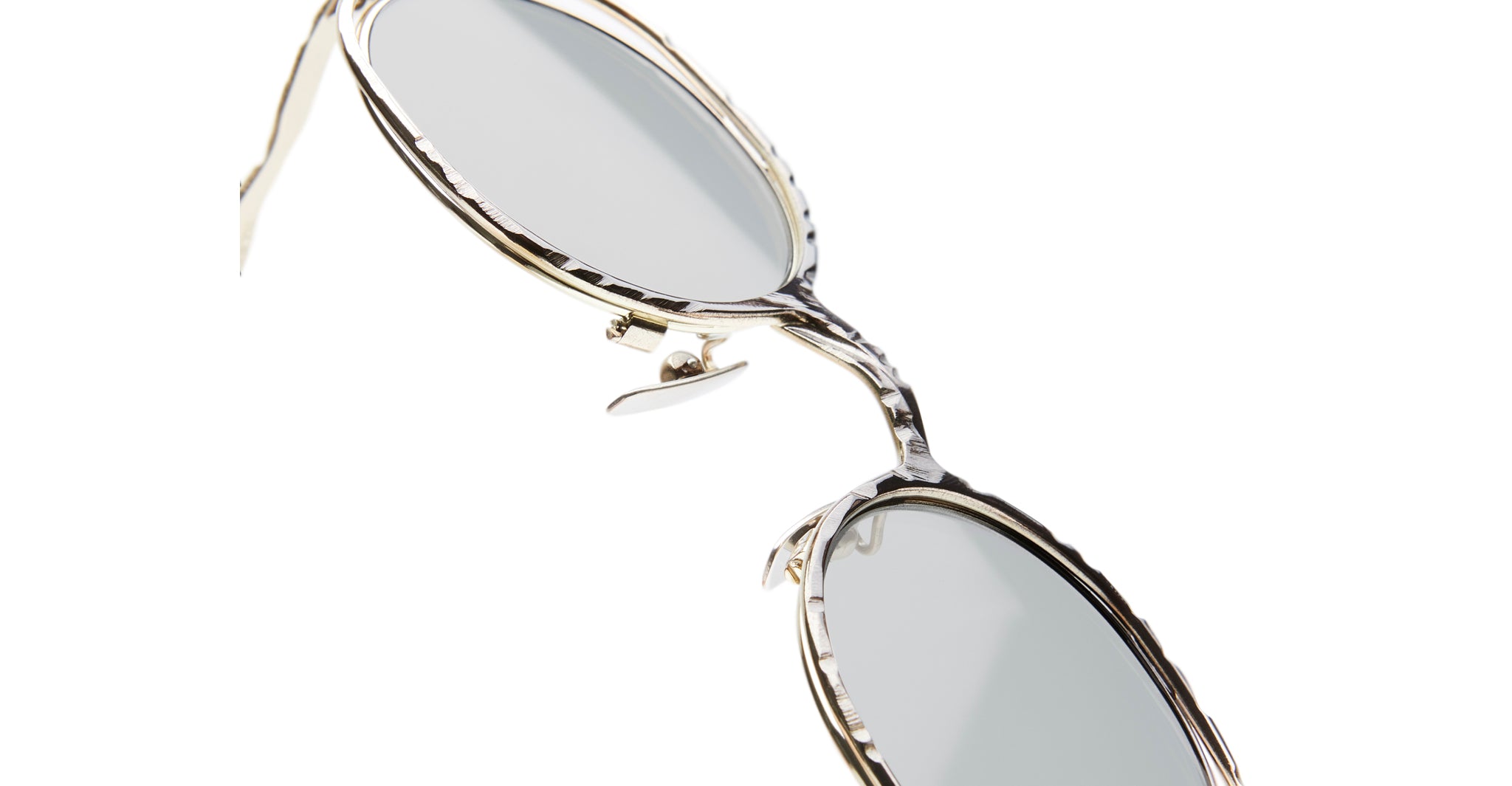 Close-up of Kuboraum H11 round sunglasses with silver metal frames and light-tinted lenses, angled on a white background.