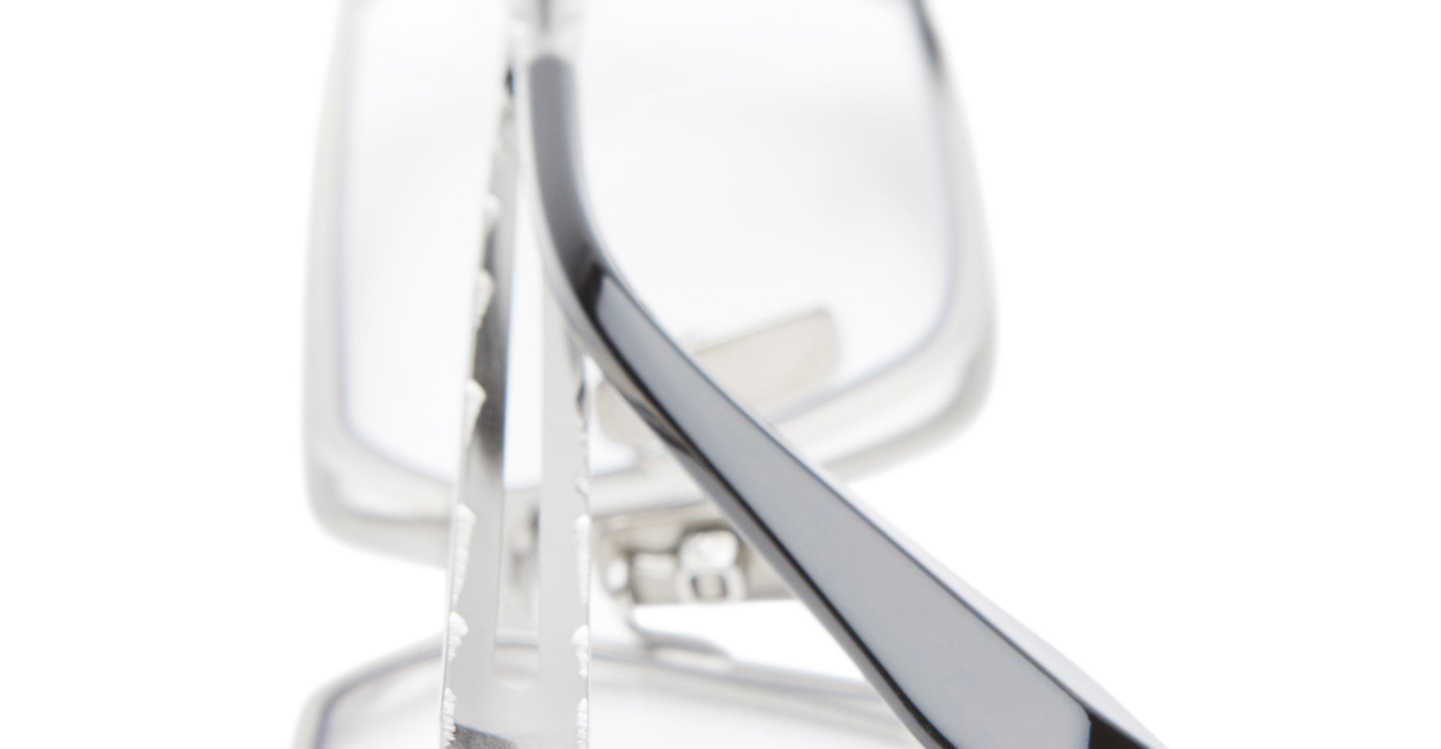 A close-up of Kuboraum H15 eyeglasses featuring thin silver metal frames and black arms, photographed against a white background.