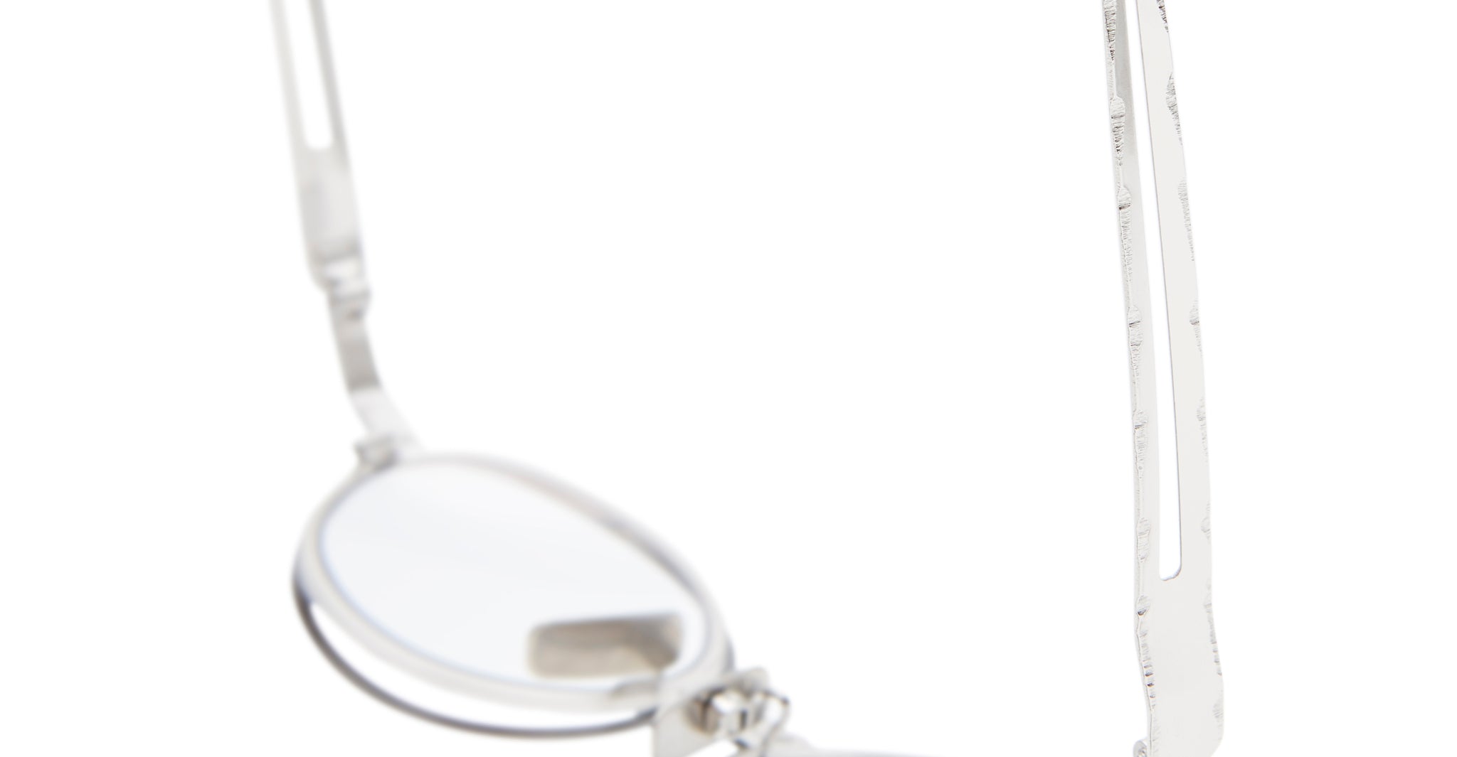A close-up of the Kuboraum H18 silver metal eyeglasses, highlighting the minimalist frame and left temple arm with clear lenses, set against a white background.